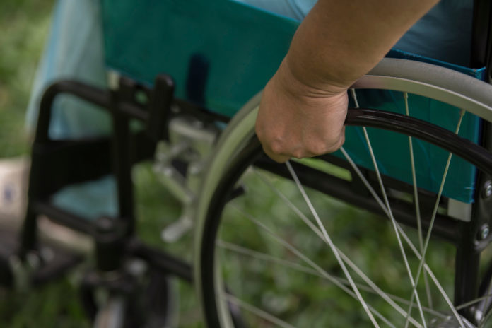 close-up-lonely-elderly-woman-sitting-on-wheelchair-at-garden-in-hospital