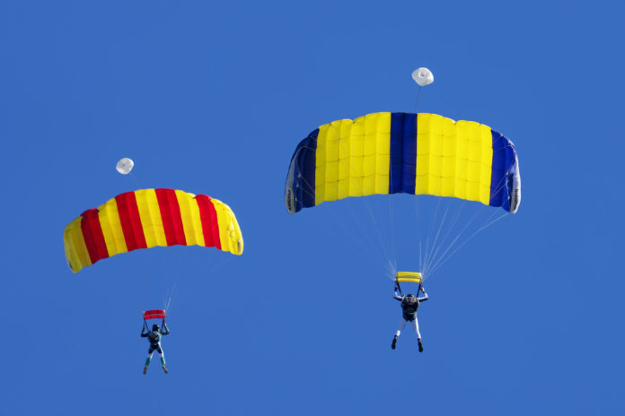 parachutists against a blue sky